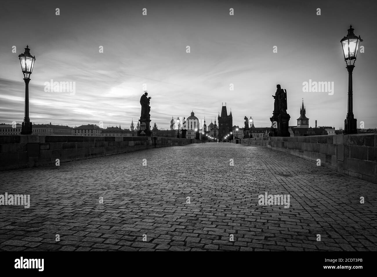 Karlsbrücke bei Sonnenaufgang, Prag, Tschechische Republik. Statuen, mittelalterliche Türme in schwarz und weiß Stockfoto