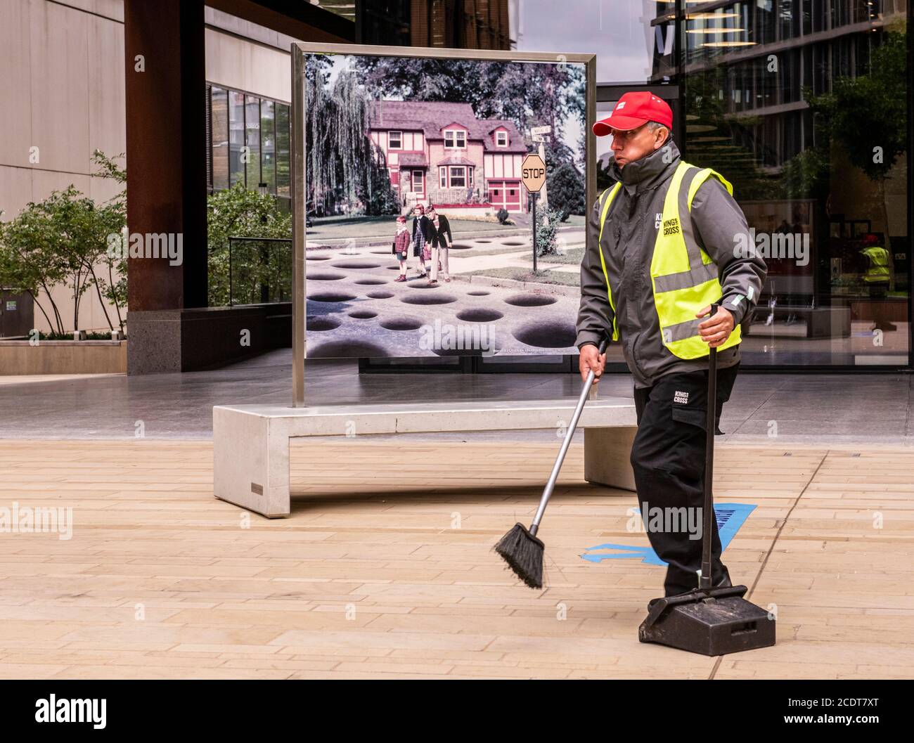 Mann trägt hoch vis fegenden concourse, Kings Cross, London, England Stockfoto