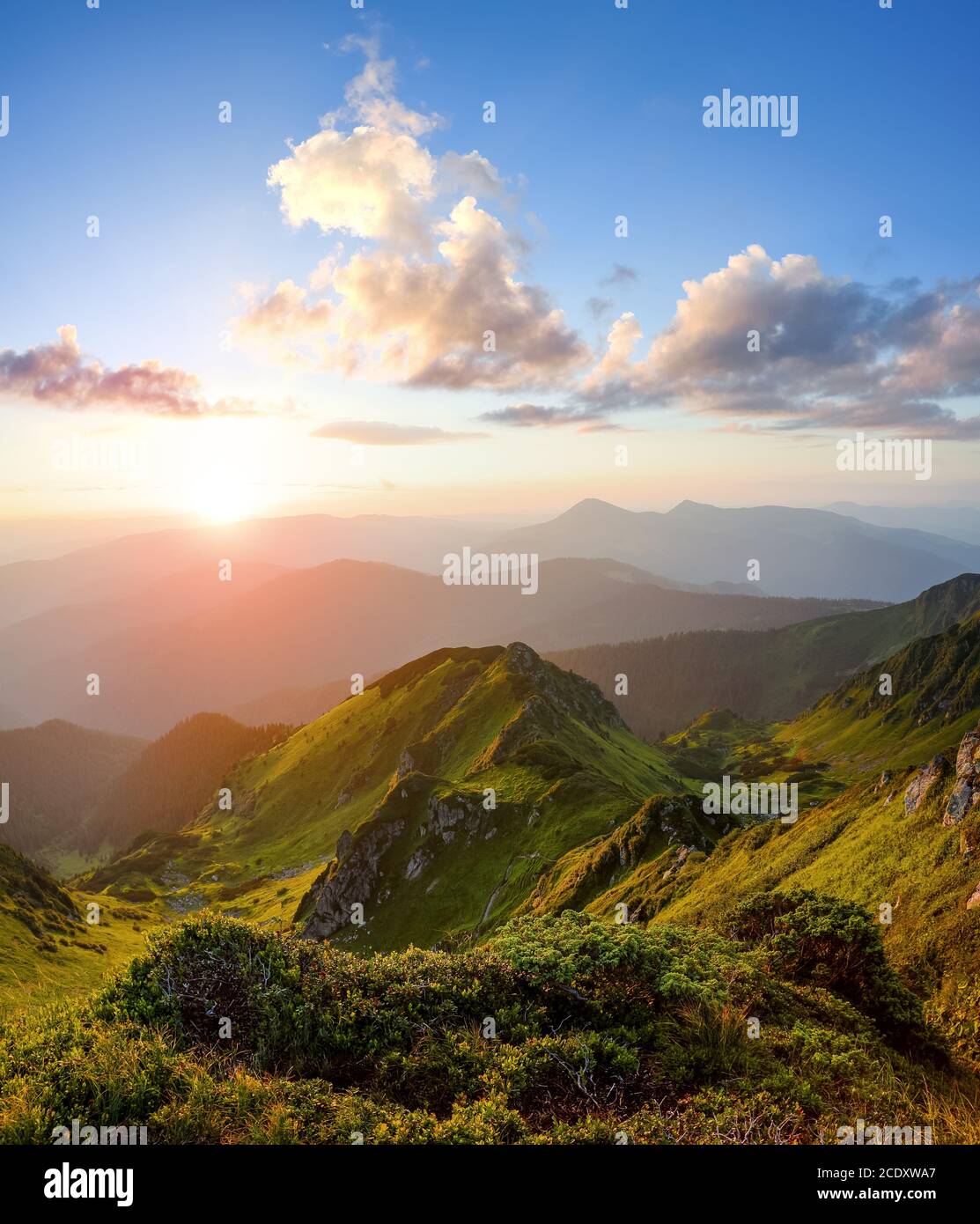 Berglandschaft mit herrlichem Sonnenaufgang, bewölktem Himmel und orangefarbenem Horizont. Frühling sonniger Morgen. Hintergrund des Hintergrundbilds. Touristischer Ort Maramur Stockfoto