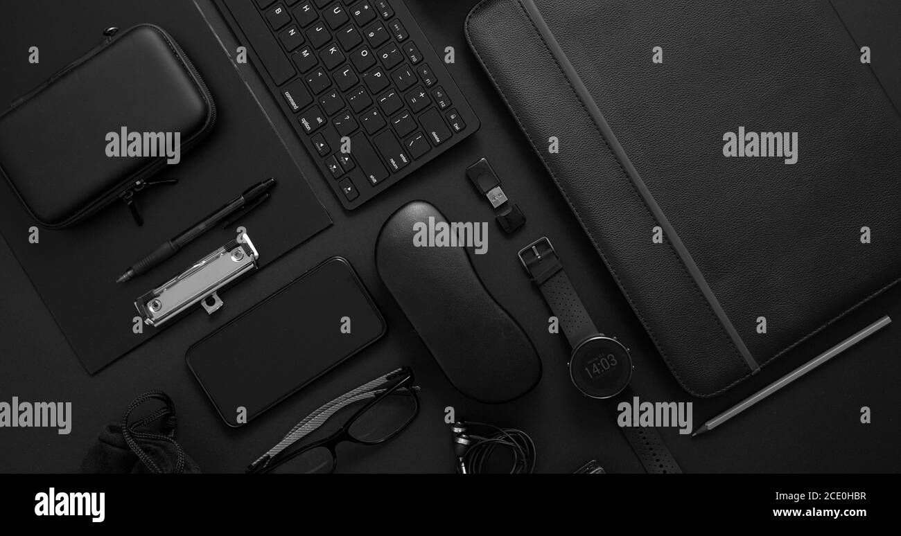 Geschäftskonzept. Flache Lay-Komposition mit verschiedenen schwarzen Gadgets auf dunkelschwarzer Oberfläche Stockfoto