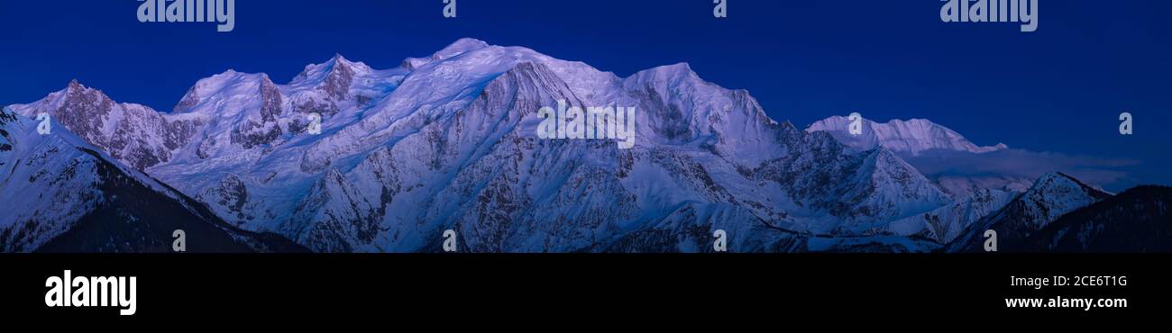 Mont Blanc Massiv bei Dämmerung mit alpinem Nachglühen. Aiguille du Midi Nadel, Bossons Gletscher, Mont Blanc Bergkette. Chamonix, Haute-Savoie (74), Stockfoto