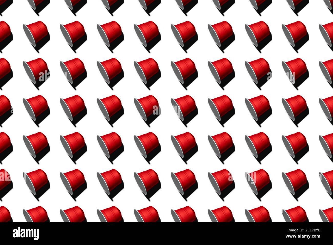 Draufsicht auf rote Kaffeepads in geraden Reihen Als nahtloses Muster auf weißem Hintergrund Stockfoto