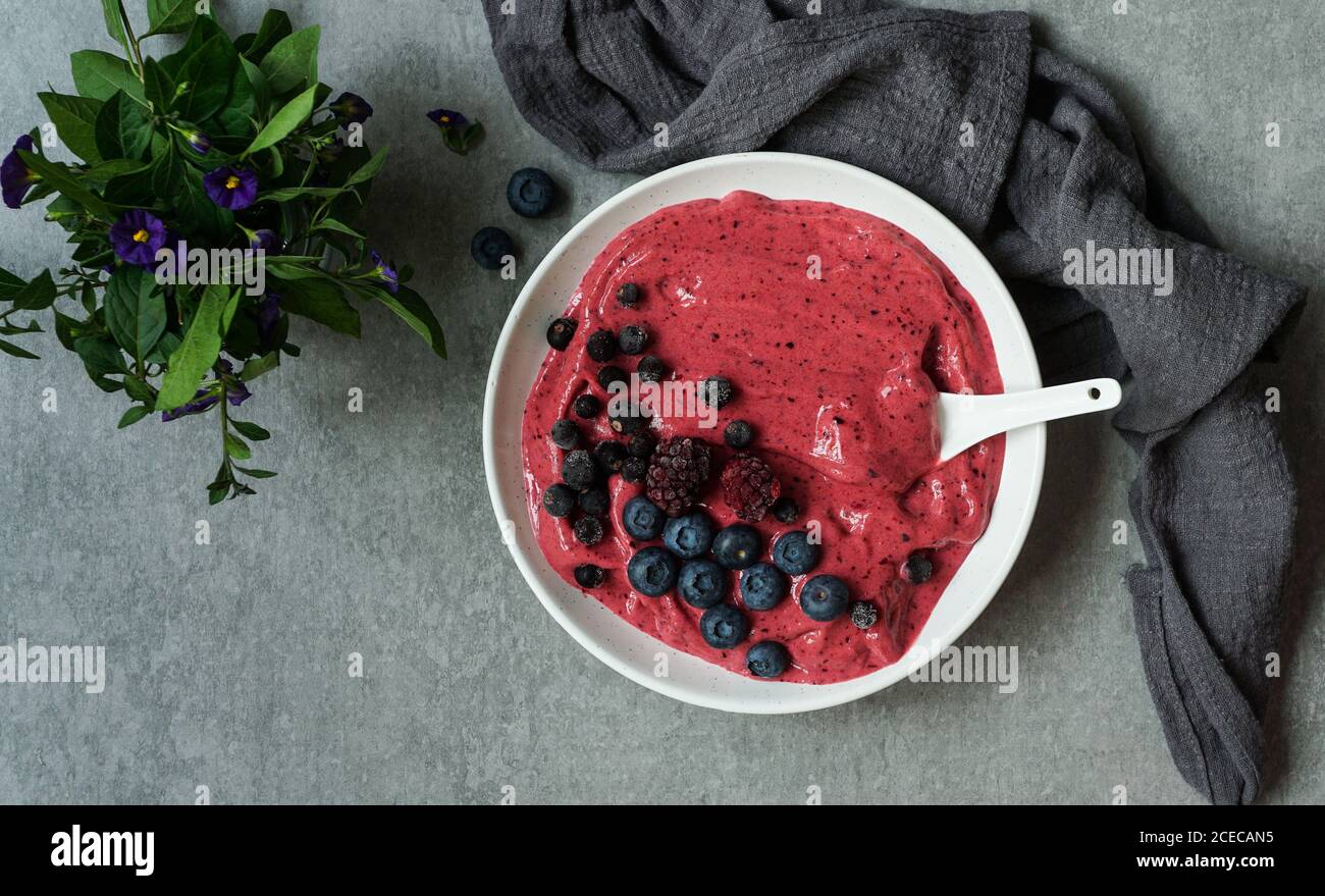 Smoothy von frischen Heidelbeeren und Himbeeren in der Schüssel in der Nähe von Serviette bog Stockfoto