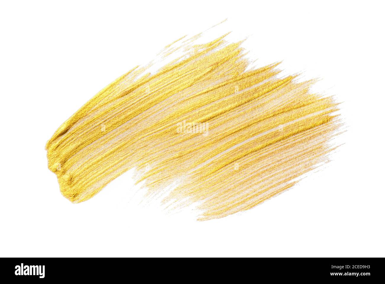 Pinselstrich aus goldenem Acryl auf weißem Hintergrund. Stockfoto