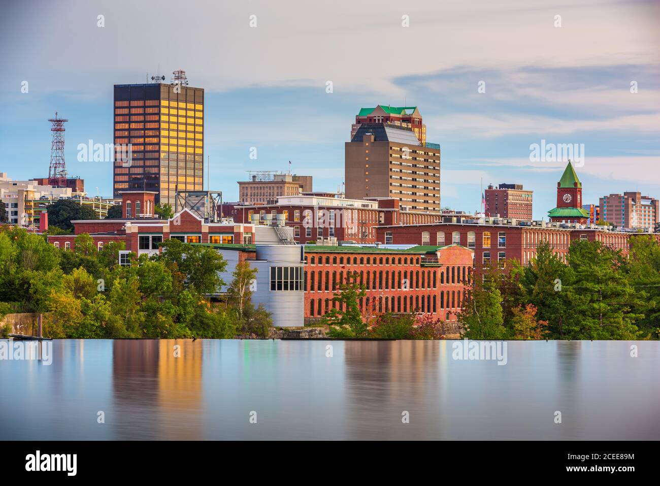 Manchester, New Hampshire, USA Skyline am Merrimack River in der Abenddämmerung. Stockfoto