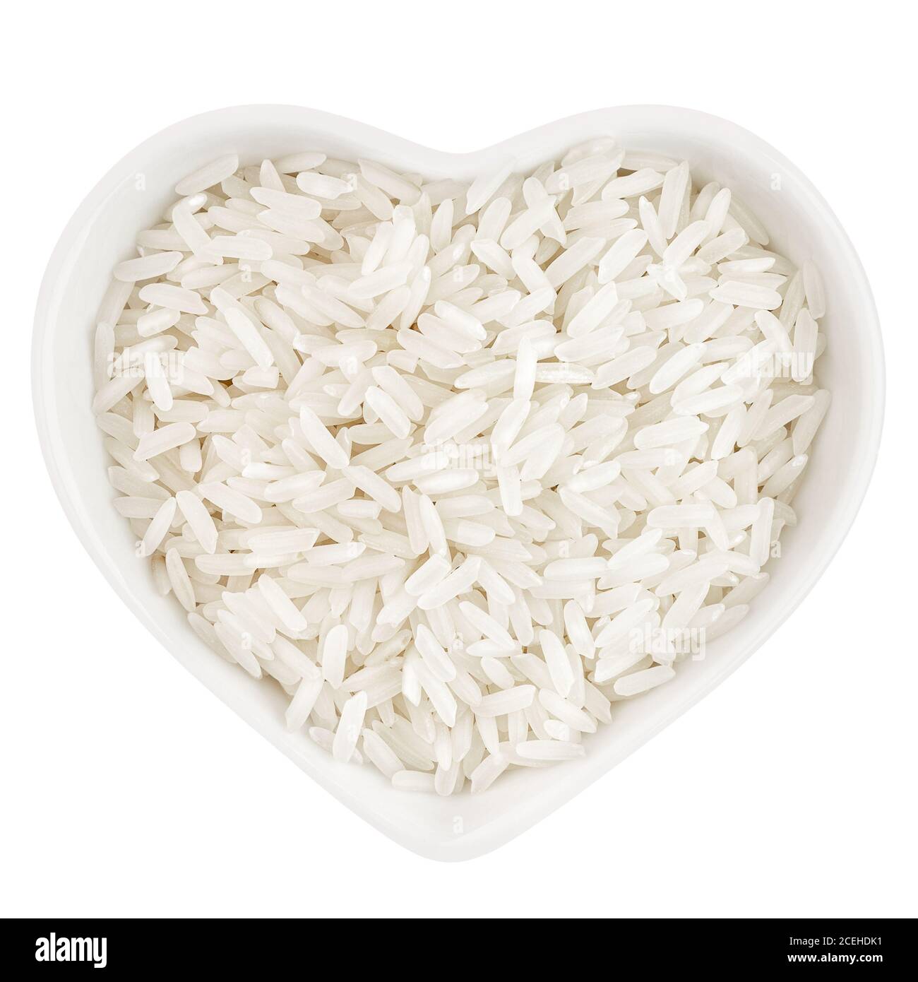 Weißer langer Reis in herzförmiger Platte Stockfoto