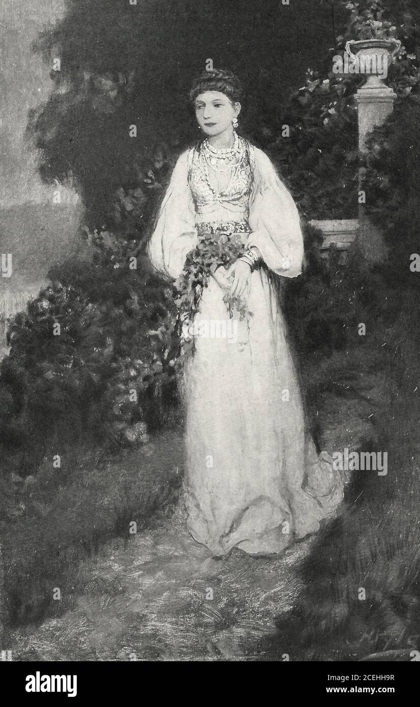 Eine stattliche Frau in Weiß in einem Garten, um 1920 Stockfoto
