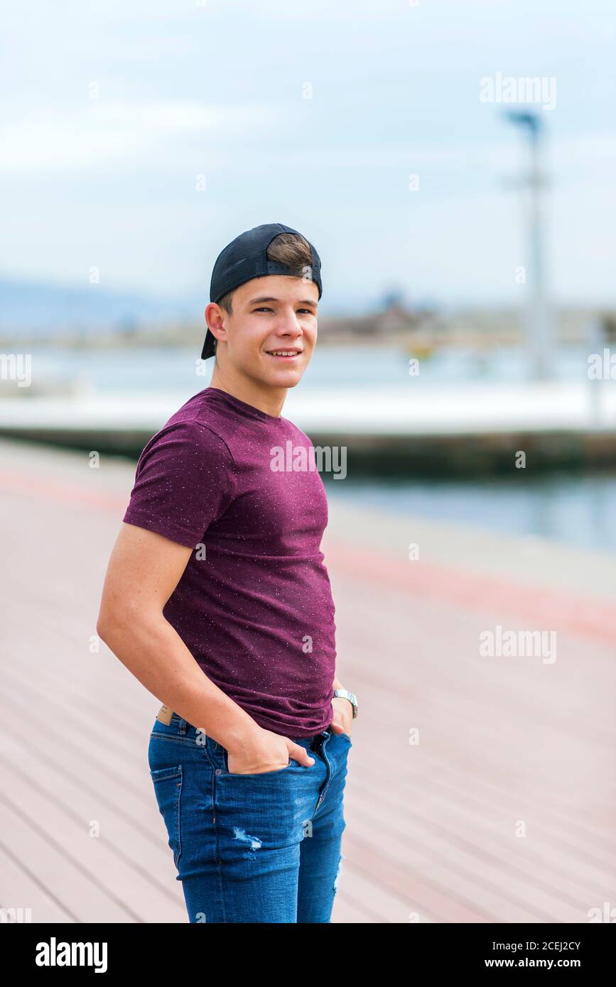 Vorderansicht eines lächelnden Teenagers in lässiger Kleidung Stehen und lächeln Stockfoto