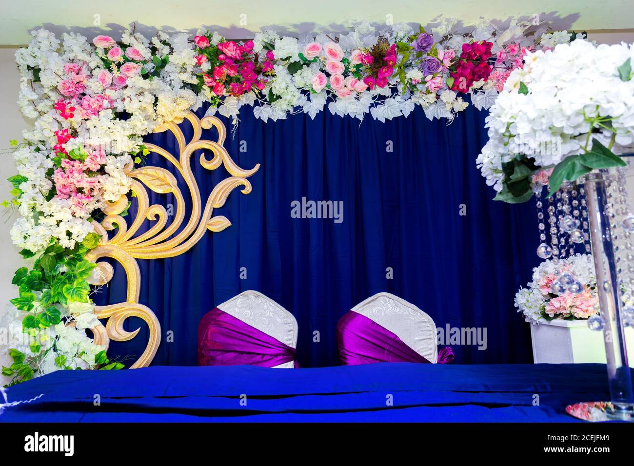 Künstliche bunte Papierblumen mit marineblauer Farbe basierte Hochzeit Bühnendekoration. Stockfoto