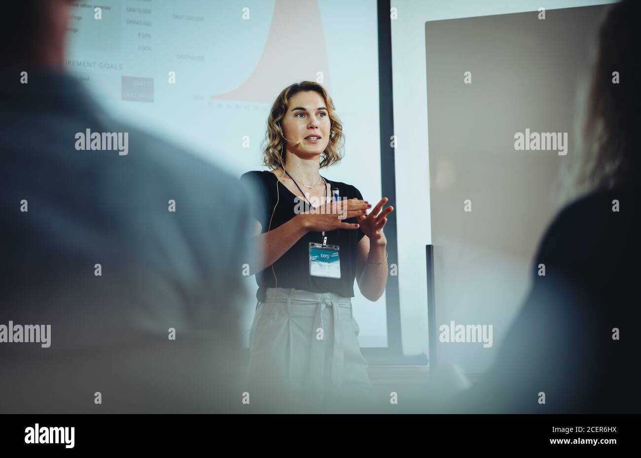Unternehmerin diskutiert Geschäftsideen in einer Konferenz. Geschäftsfrau hält Vortrag während eines Seminars. Stockfoto