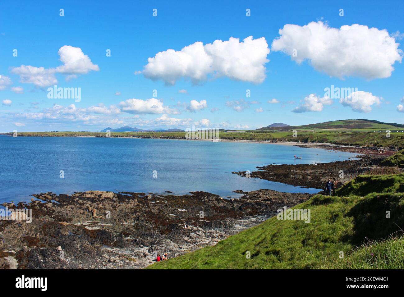 Wunderschöne Landschaft der blauen Irischen See an der felsigen Küstenbucht von Porth Colmen, Nordwales an einem sonnigen Tag Stockfoto
