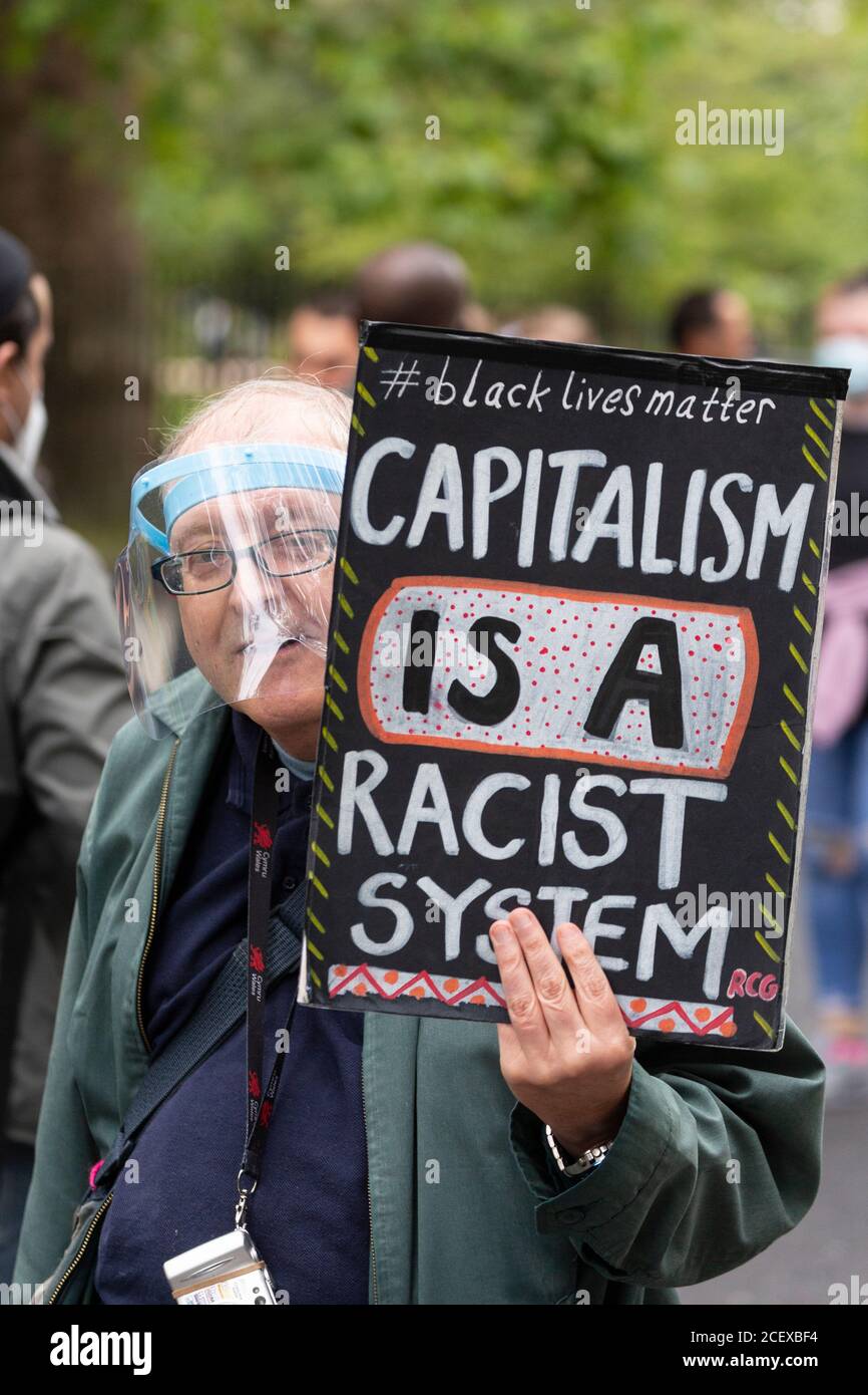 Ein älterer Mann, der ein Gesichtsvisier trägt und ein Schild an der Million People March hält, London, 30. August 2020 Stockfoto