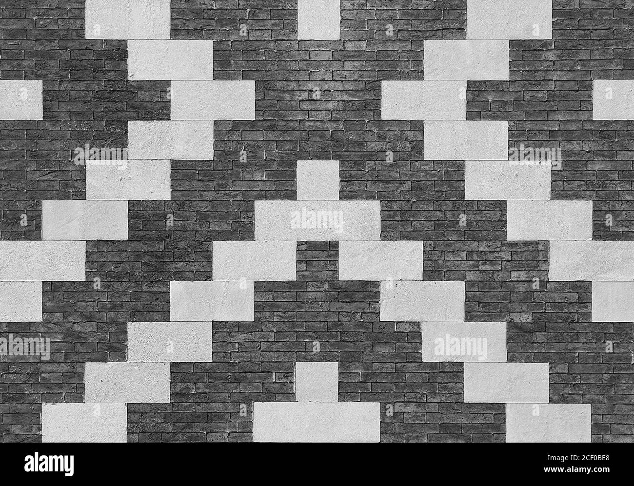 Grauer Ziegel mit weißem Stein Verbundwand als Hintergrund (Schwarzweiß) Stockfoto