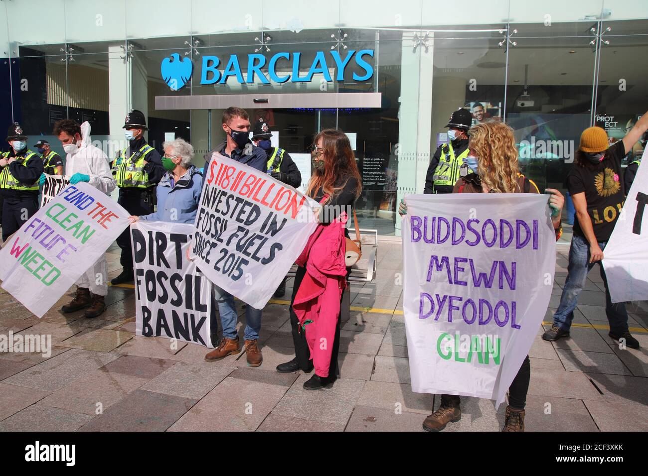 Cardiff, Wales, Großbritannien. September 2020. Extinction Rebellion Protestierende vor der Barclays Bank am dritten Aktionstag in Cardiff, 3. September 2020 im Rahmen des Herbstaufstandes. Demonstranten heben die Investitionen der Banken in fossile Brennstoffe und ihre Greenwashing-Politik hervor.Demonstranten halten Banner auf Walisisch und Englisch.Kredit: Denise Laura Baker/Alamy Live News Kredit: Denise Laura Baker/Alamy Live News Stockfoto