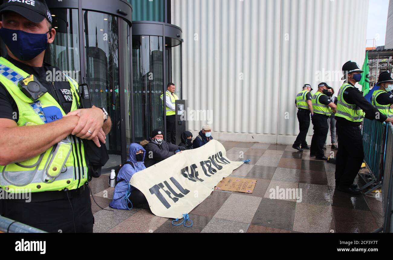 Cardiff, Wales, Großbritannien. September 2020. Extinction Rebellion Protestierende vor der BBC am dritten Aktionstag in Cardiff, 3. September 2020 im Rahmen des Herbstaufstandes. Demonstranten drängen die BBC, die Wahrheit über den Klimawandel zu sagen. Demonstranten sitzen vor der BBC in Cardiff und blockieren den Haupteingang mit einem Banner, das sagt, die Wahrheit zu sagen, flankiert von der Polizei Kredit: Denise Laura Baker/Alamy Live News Kredit: Denise Laura Baker/Alamy Live News Stockfoto