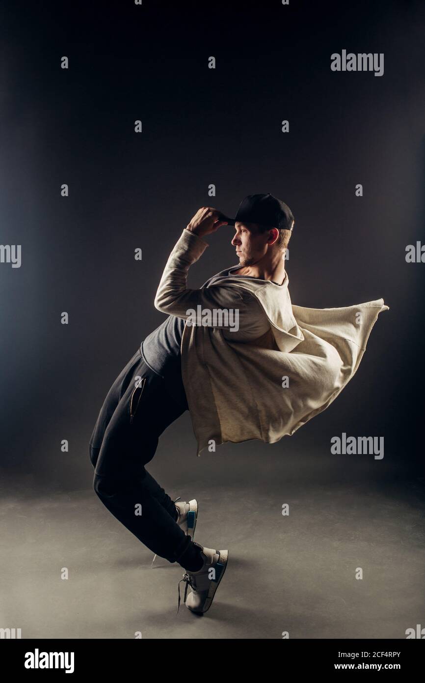 Eine schöne junge Hip Hop Tänzer tanzen zeitgenössischen urbanen Street Dance in leeren klare graue Wand Hintergrund Konzept. Stockfoto