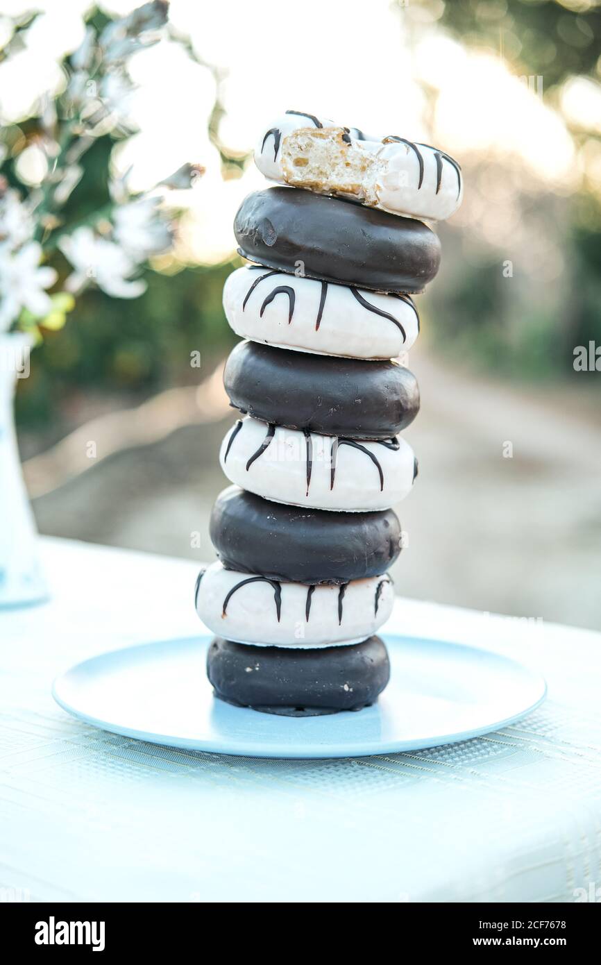 Leckere Donuts mit Glasur und Schokolade Ganache auf dem Teller gestapelt Stockfoto