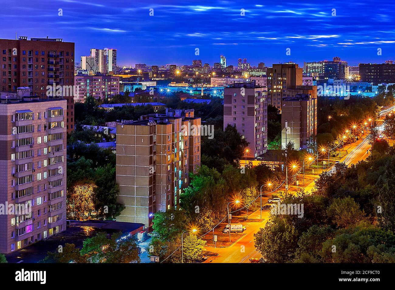 Nachtstraße in Lichtern mit blauem Himmel und gelber Straße Stockfoto