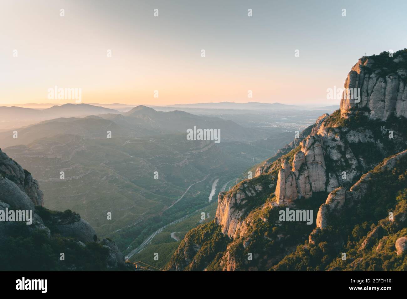 Malerische Landschaft mit hohen Felsen und gewundenen Straßen zwischen Grün Wälder am sonnigen Morgen Stockfoto