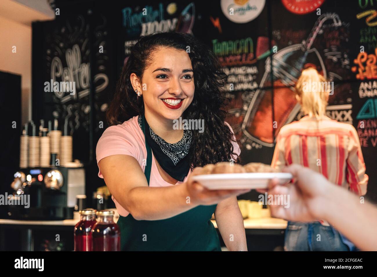 Barkeeper überreicht einem Gast Essen Stockfoto