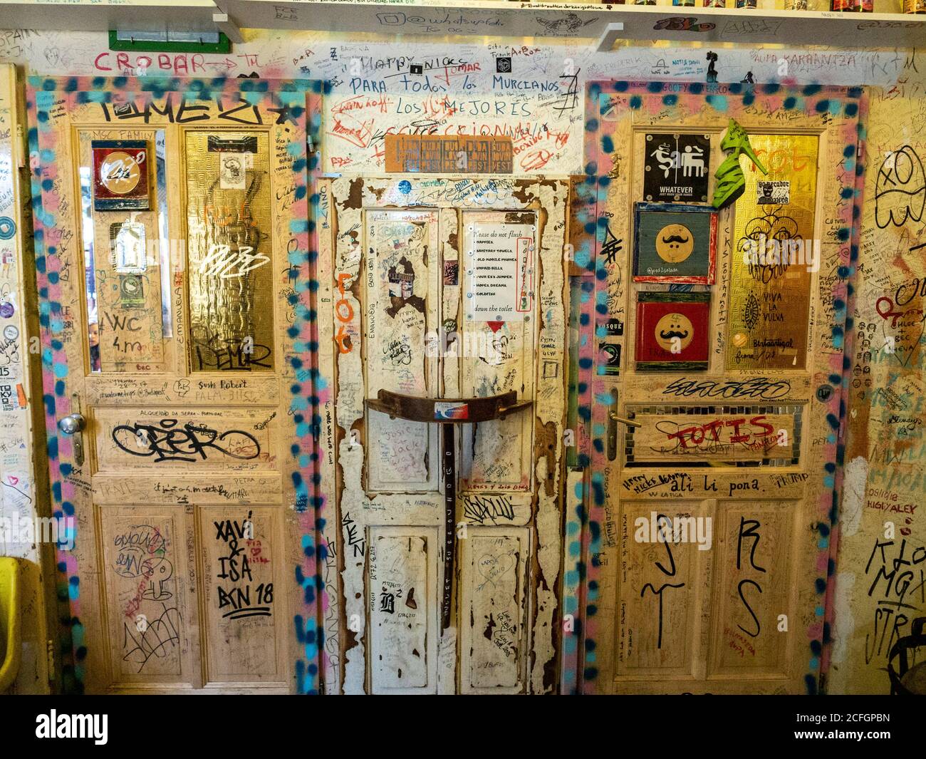 Graffiti bedeckte Toilettentüren in einer Ruine Bar: Die Türen der Waschräume in der Szimplar Ruine Bar sind voll und ganz von den Graffiti und Kunst der Gönner der Bar gewütet. Stockfoto