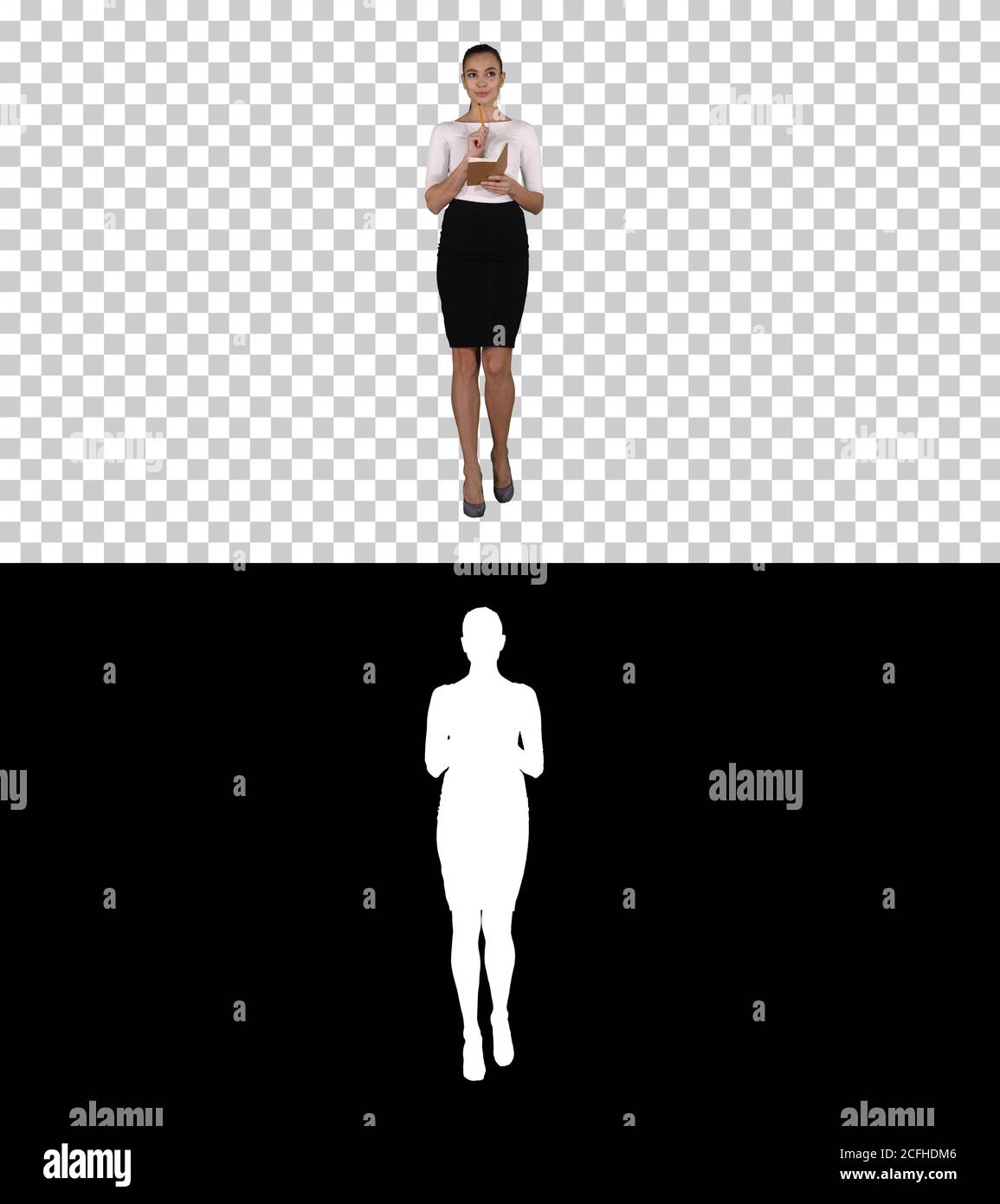Junge Frau, die beim Gehen Notizen macht, Alpha Channel Stockfoto