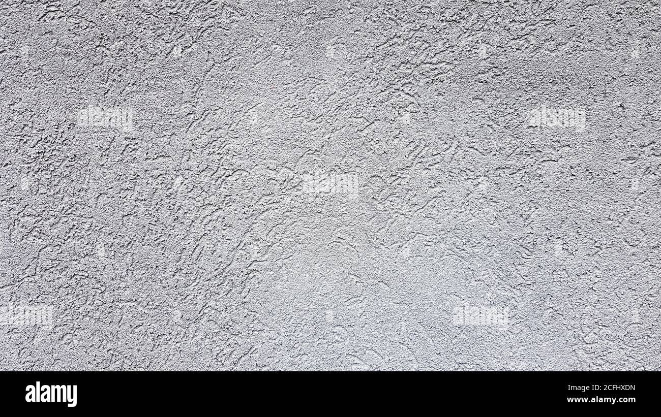 Grauer abstrakter Hintergrund. Wunderschöner, grau strukturierter Stuck an der Wand. Hintergrund aus grauem Stuck Stockfoto