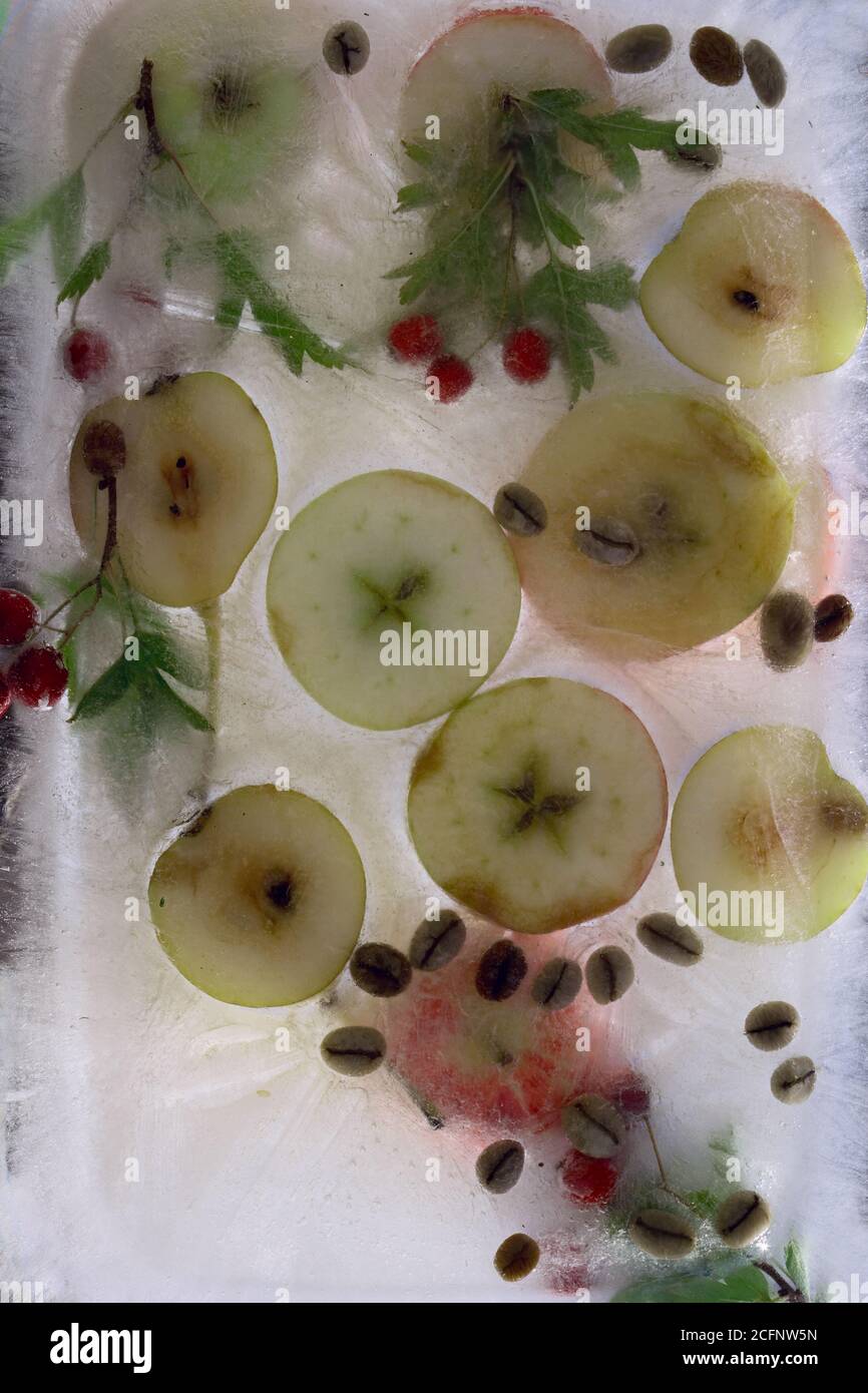 Hintergrund frische Saison Apfel und hgreen Kaffeebohnen in Eis würfel mit Luftblasen Stockfoto