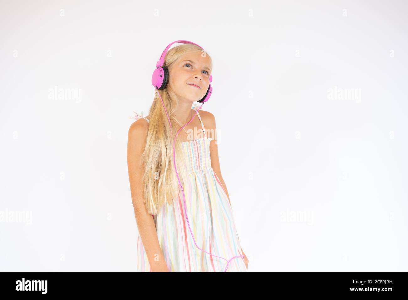 Lächelnd schönes Mädchen mit Kopfhörern auf weißem Hintergrund Stockfoto