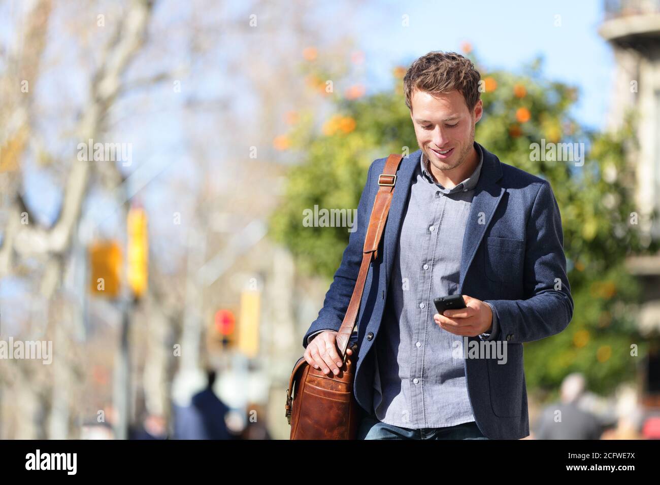 Junge städtische Geschäftsmann Profi auf Smartphone zu Fuß in der Straße mit Handy-App SMS-SMS-Nachricht auf Smartphone tragen smart Lässig Stockfoto