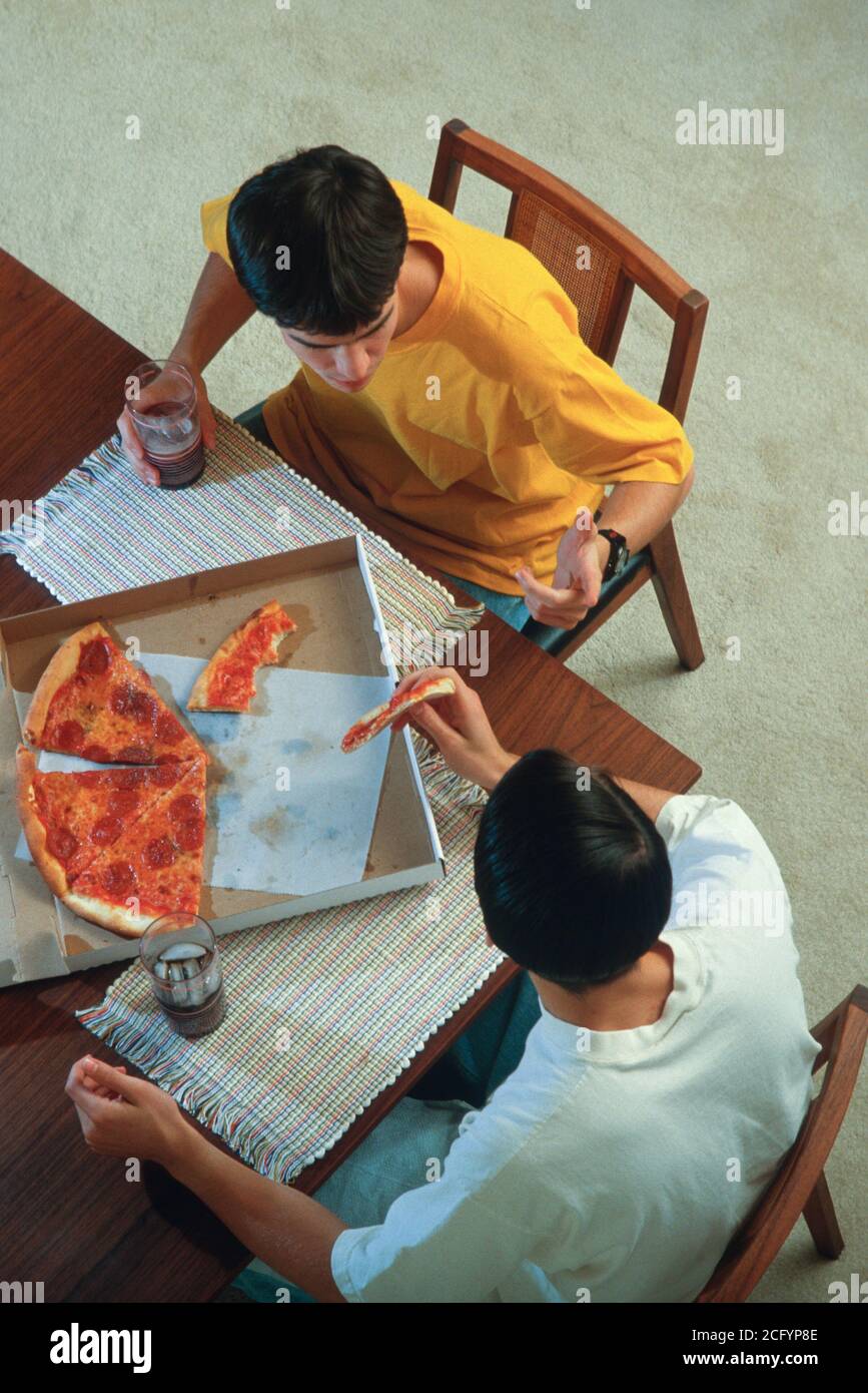 Zwei Teenage-Jungen essen eine Pizza Home, USA Stockfoto