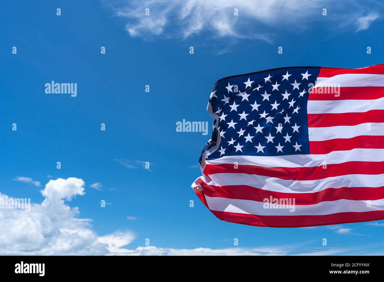 Winkende USA Flagge unter blauem Himmel Hintergrund. Stockfoto