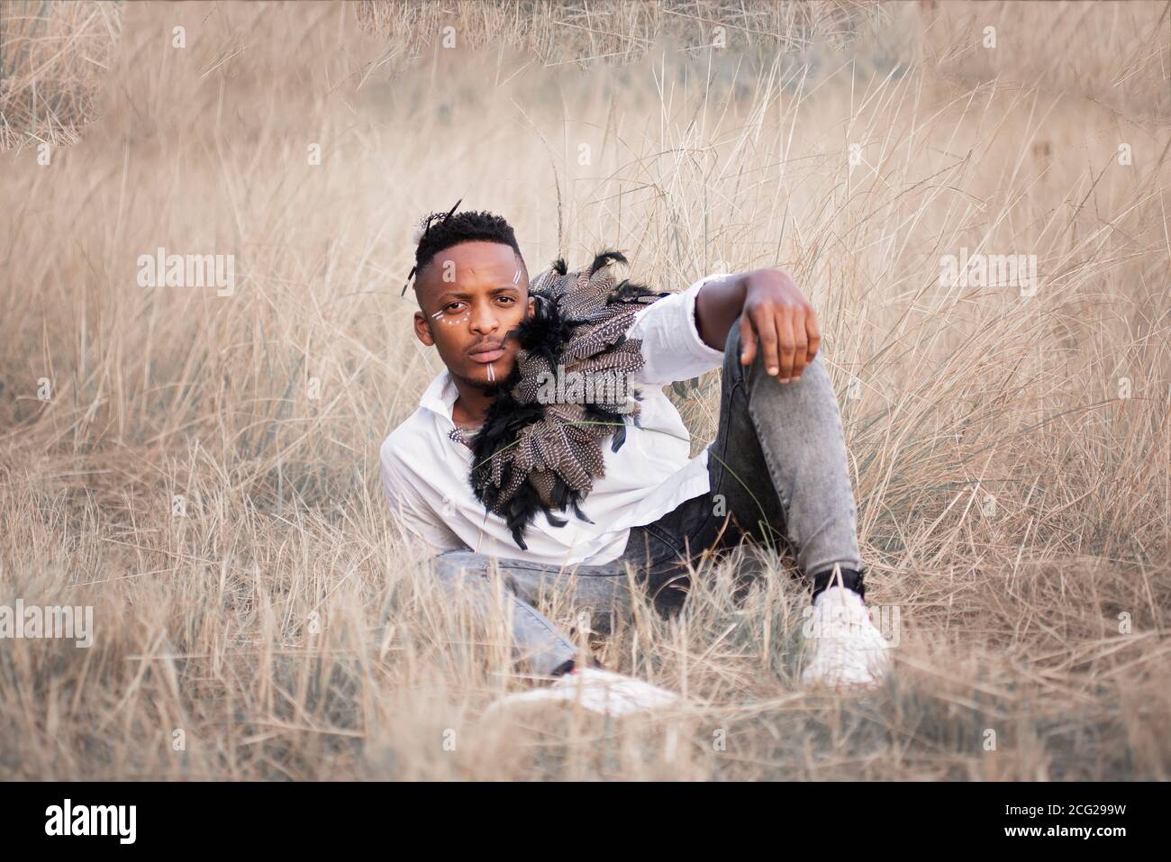 afrikanischer Gentleman im afrikanischen Busch mit Buschhut in Das Gras Stockfoto