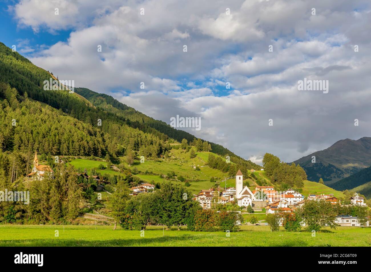 Das Bergdorf Graun im Vinschgau, gegen einen schönen Himmel, an einem sonnigen Sommertag, Südtirol, Italien Stockfoto