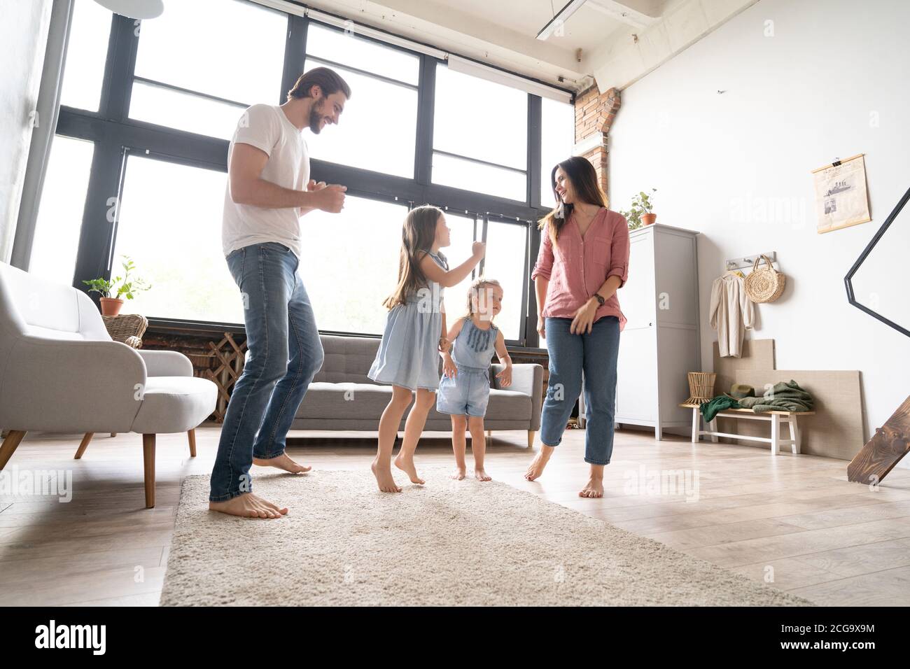Glückliche Familie Mutter Vater und Kind Tochter tanzen zu Hause. Stockfoto