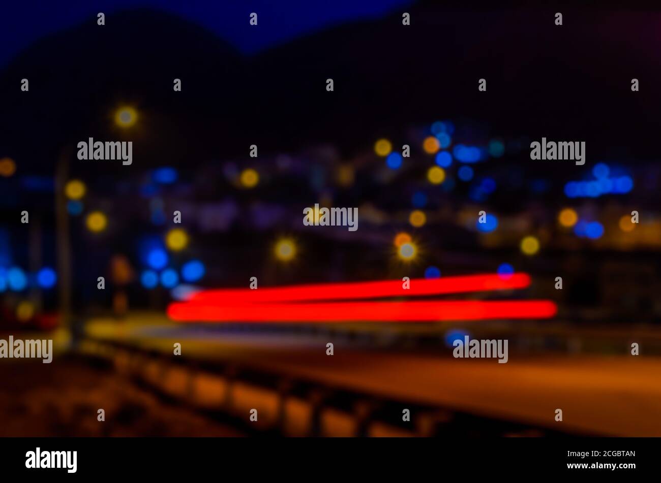 Tail Light Motion Trails und Lichtbokeh im Hintergrund - Dunkles Bild - Langzeitbelichtung - Nachtfotografie Stockfoto