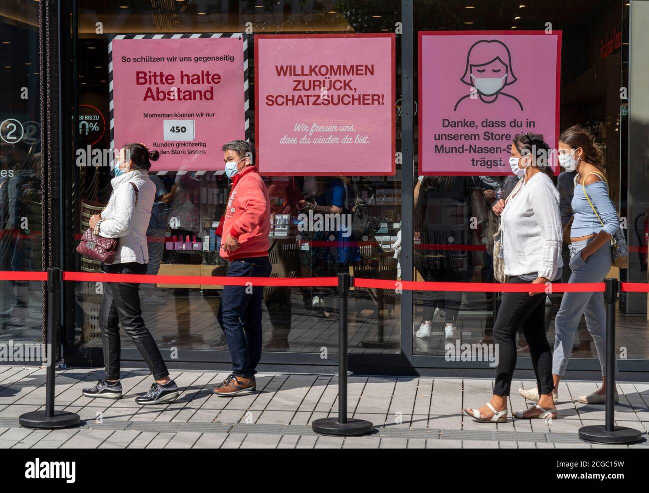 Schlange vor einem Bekleidungsgeschäft, Koronaschutzmaßnahmen, Plakate auf Zwangsmasken, Distanz, Düsseldorf, NRW, Deutschland, Stockfoto