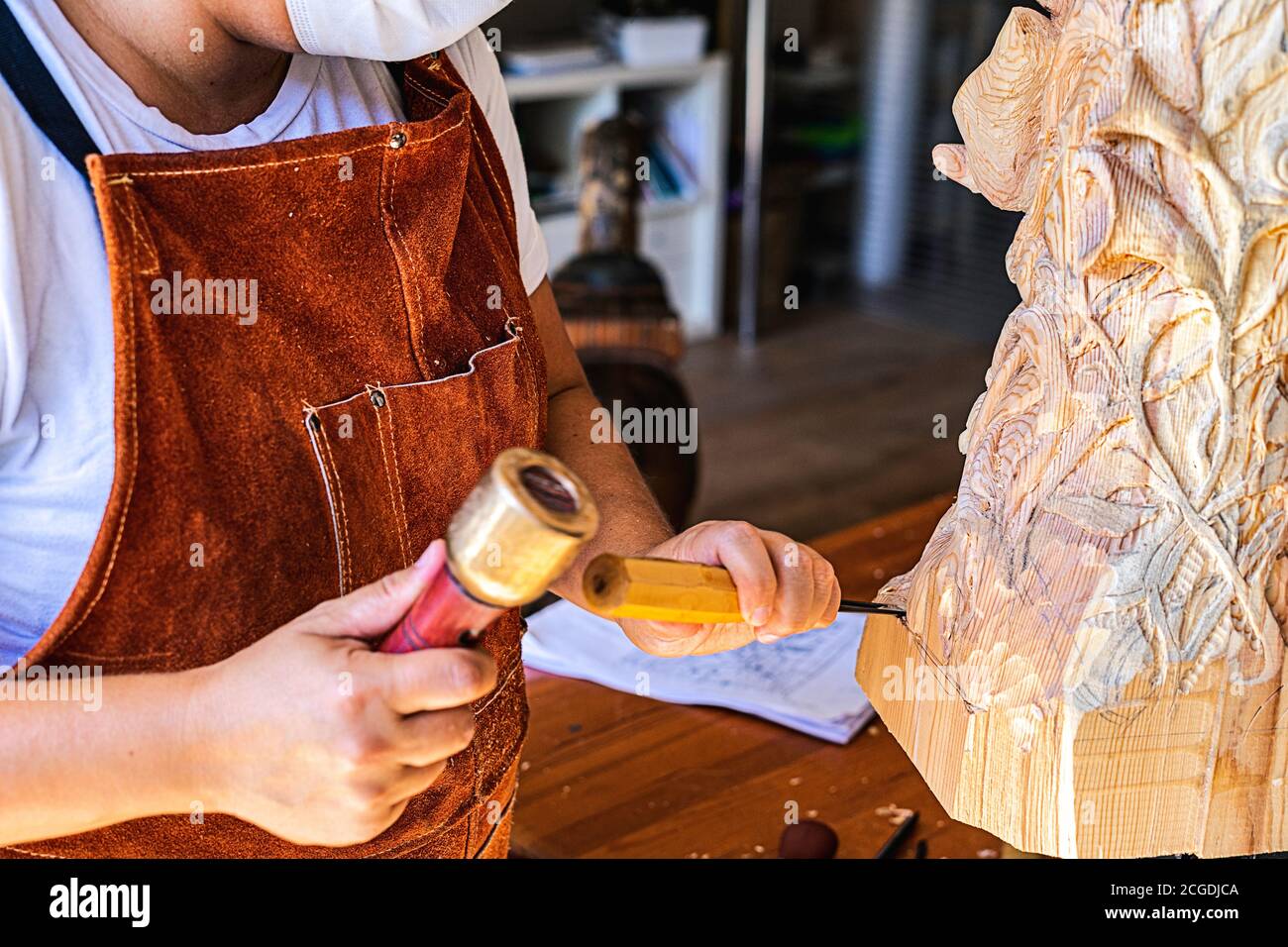 Bildhauerin mit Maske Schnitzerei Holzfigur Stockfoto