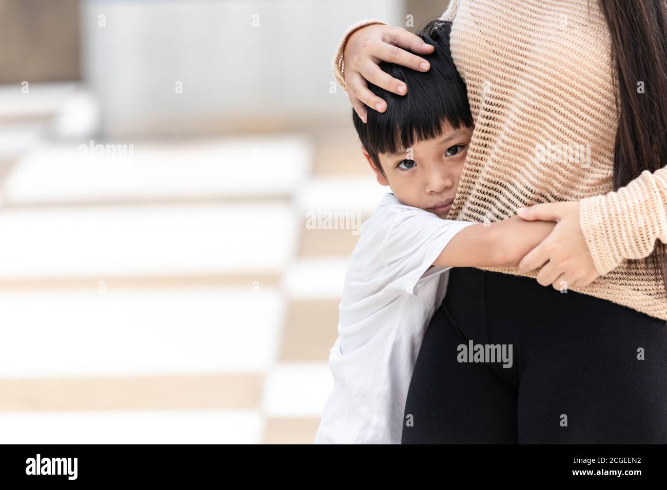 Der Junge hatte Angst und umarmte seine Mutter. Asiatische kleines Kind ist traurig und Angst. Häusliche Familie Gewalt Konzept. Stockfoto