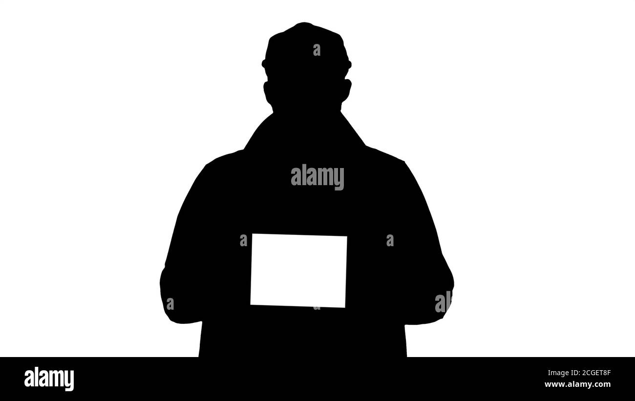 Silhouette Mann zu Fuß und halten Tablet mit weißem Bildschirm Mockup. Stockfoto