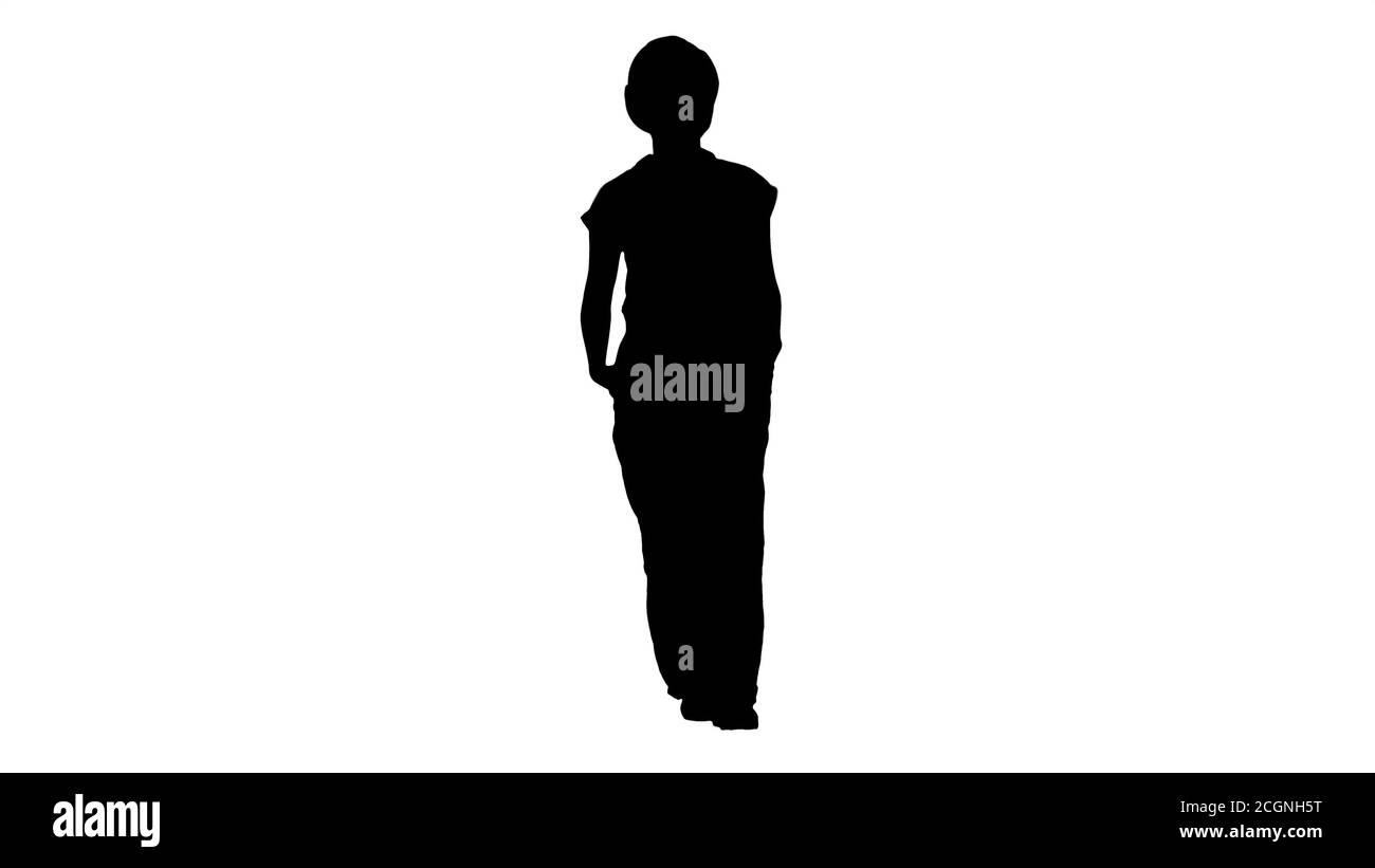 Silhouette Frau Baumeister mit Händen in den Taschen zu Fuß und Telli Stockfoto