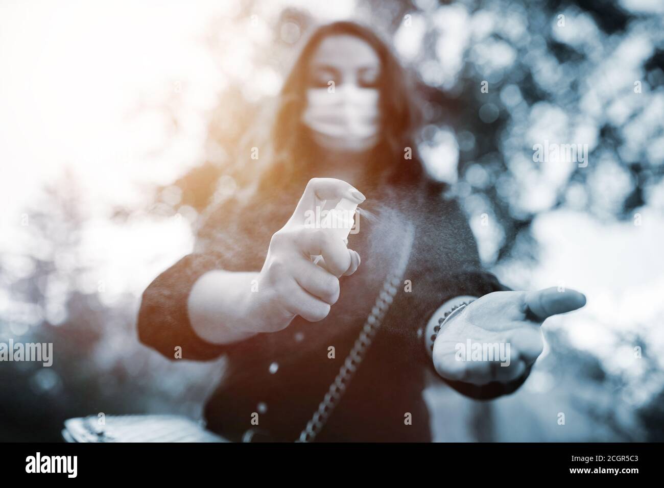 Junge Frau in medizinischer Maske während Coronavirus Stockfoto
