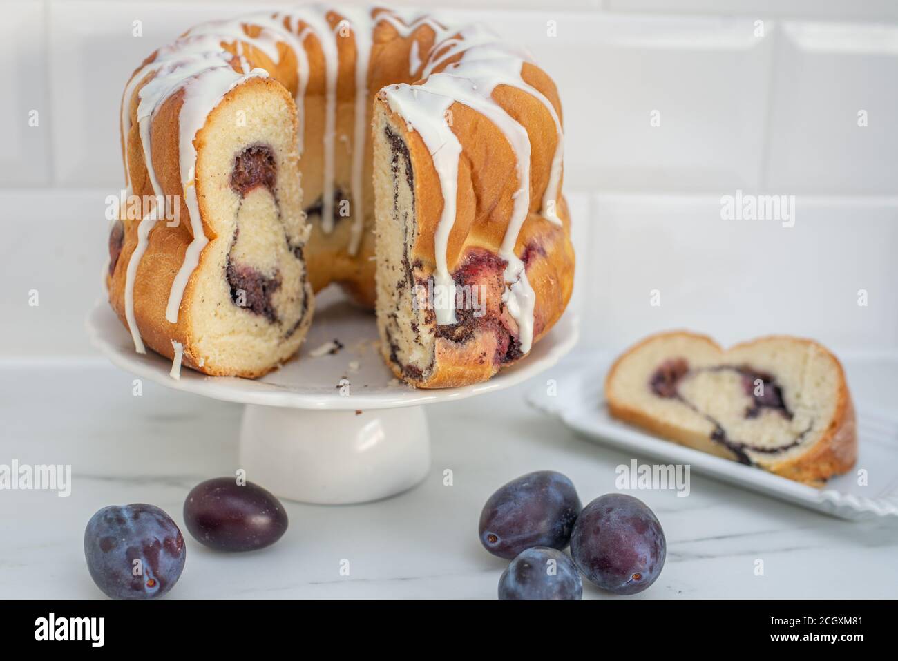 deutscher Gugelhupf Kuchen gefüllt mit Mohn und Pflaumen Stockfoto