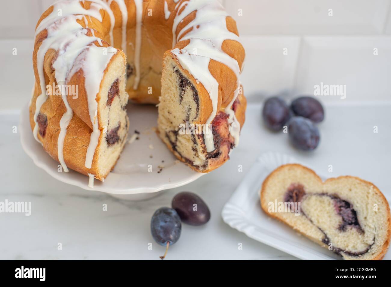 deutscher Gugelhupf Kuchen gefüllt mit Mohn und Pflaumen Stockfoto