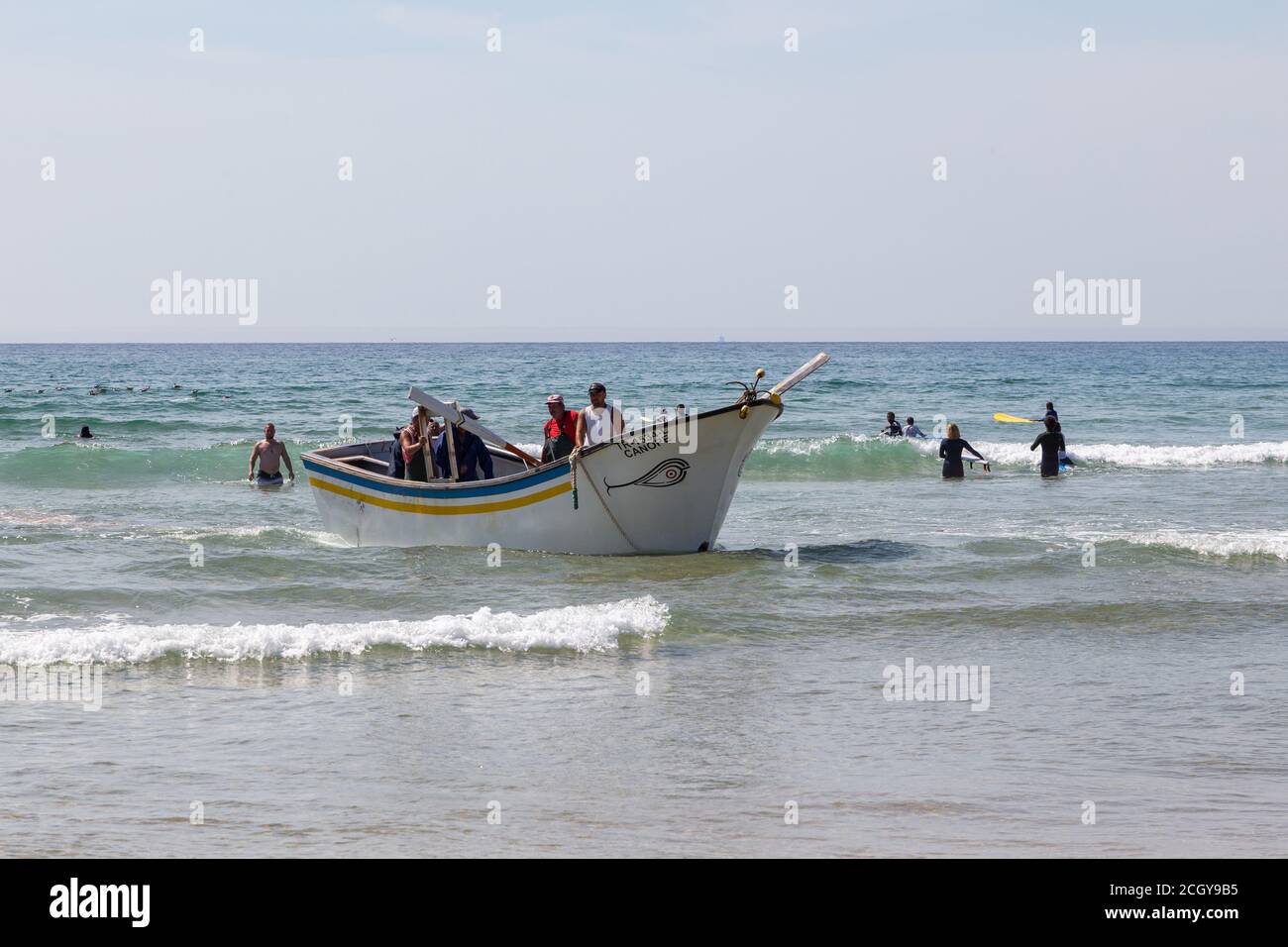 Costa da Caparica, Portugal - 10. September 2020: Eine Kunst der Fischer Schleppnetzfischfang vom touristischen Strand mit einem Traktor. Urlauber beobachten und hellen Stockfoto