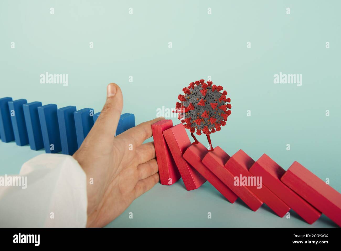 Konzept der covid19 Coronavirus Pandemie mit fallenden Kette wie ein Domino-Spiel. Ansteckung und Infektionsverlauf. Cyanfarbener Hintergrund Stockfoto