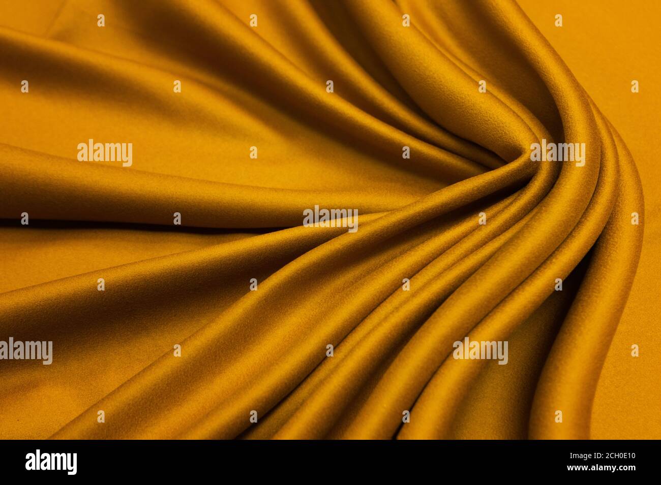 Nahaufnahme Ocker Farbe natürliche Wolle Kaschmir Textur, wellige Falten. Stockfoto