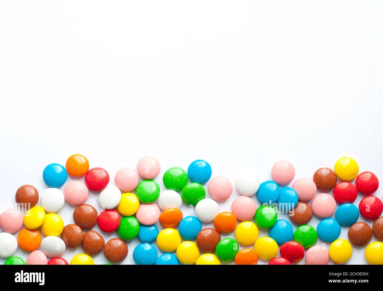 Farbige Zuckerbälle auf weißem Hintergrund. Schokolade Bonbons mit bunten Zucker Glasur bedeckt. Für Text platzieren Stockfoto