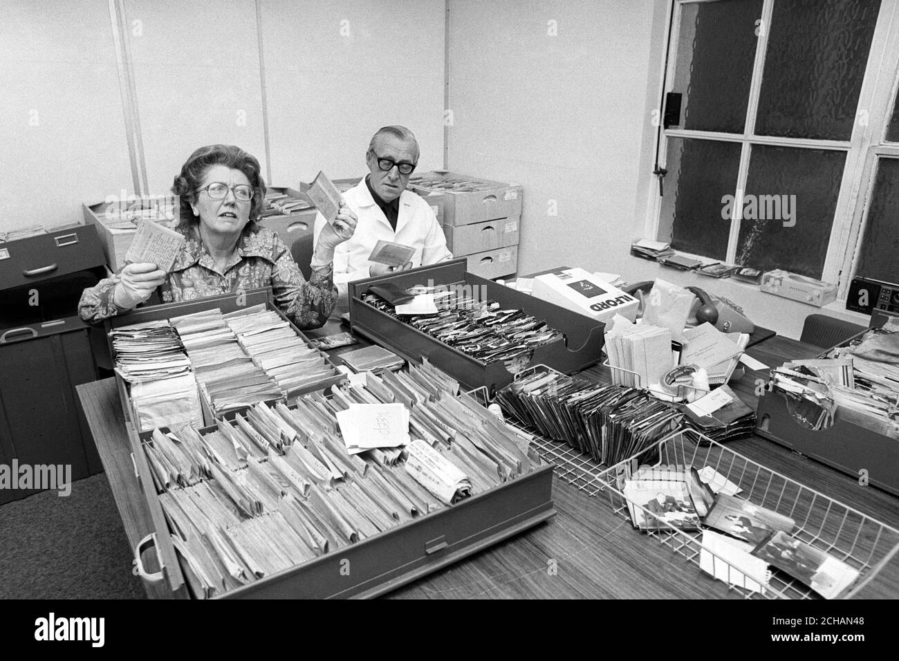 Herr und Frau J. Richards haben die Fotobibliothek der PA durchsortiert. Frau Richards war früher Chef Bibliothekar und Herr Richards war früher Picture News Editor. Stockfoto