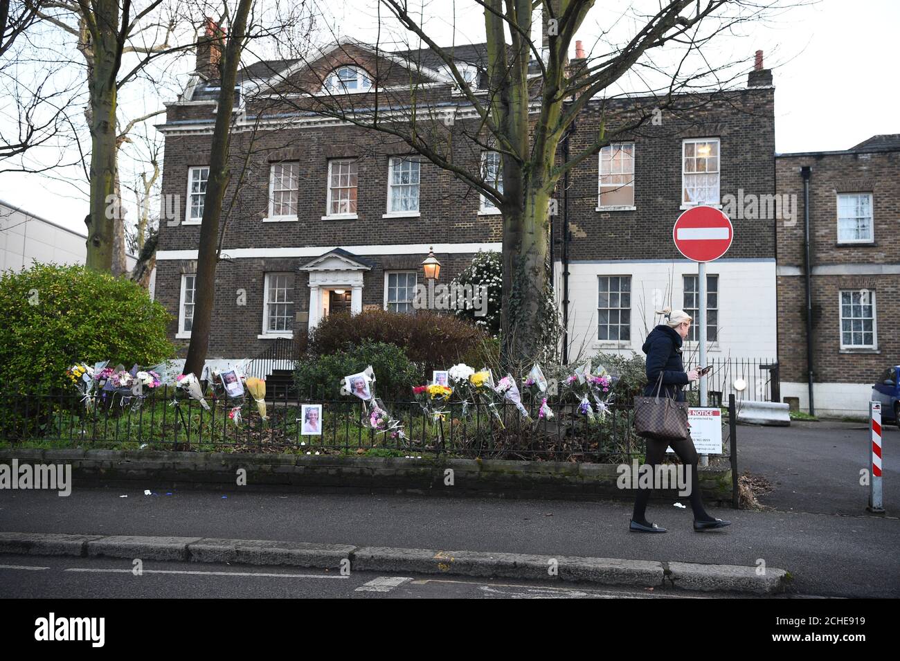 Eine Frau geht an floralen Andenken an der Szene in der Forest Road im Osten Londons vorbei, wo eine 21-jährige Frau starb, nachdem sie von einem Polizeiauto getroffen wurde, das auf einen Anruf vom 999. September reagiert hatte. Stockfoto